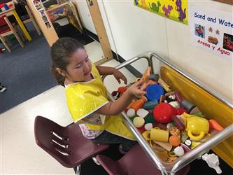 Child playing at water table